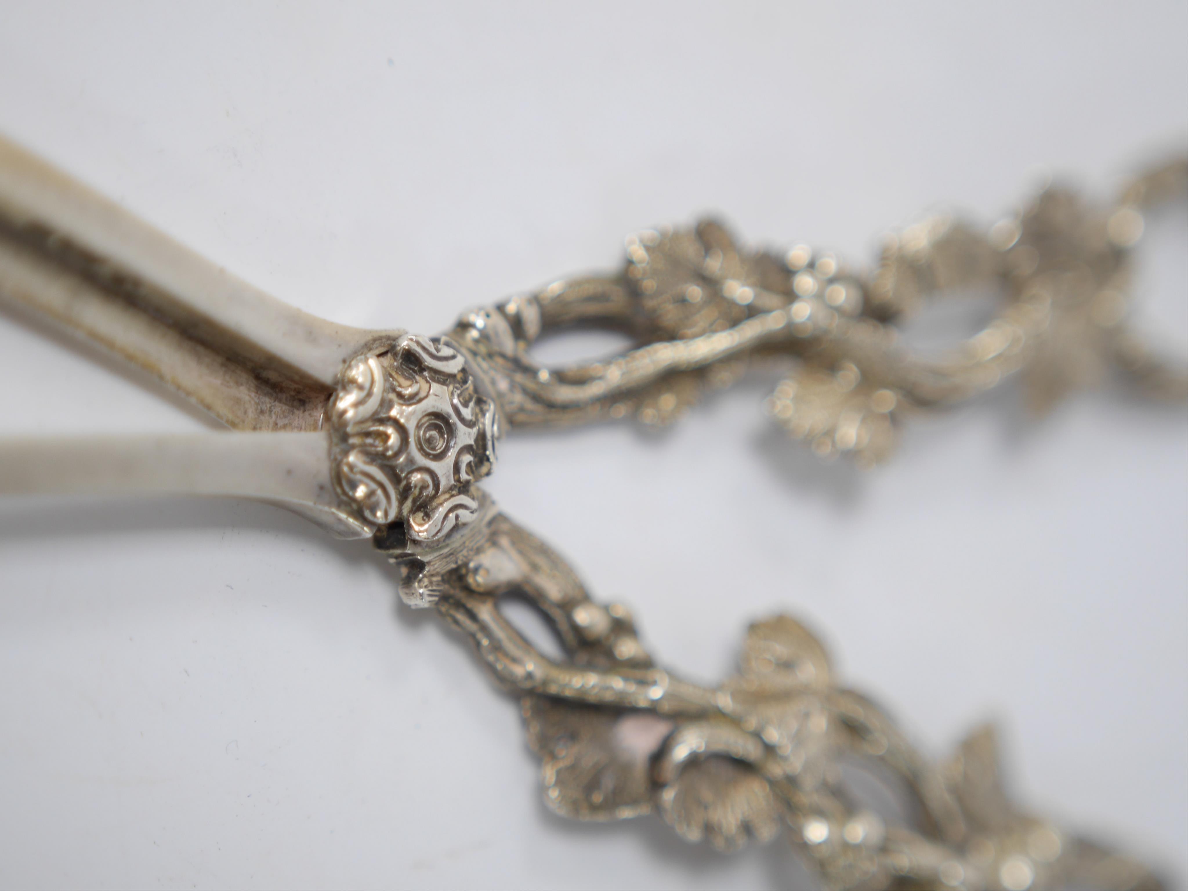 A pair of Victorian silver grape shears with fruiting vine handles, Martin, Hall & Co, Sheffield, 1884, 17.1cm. Condition - good